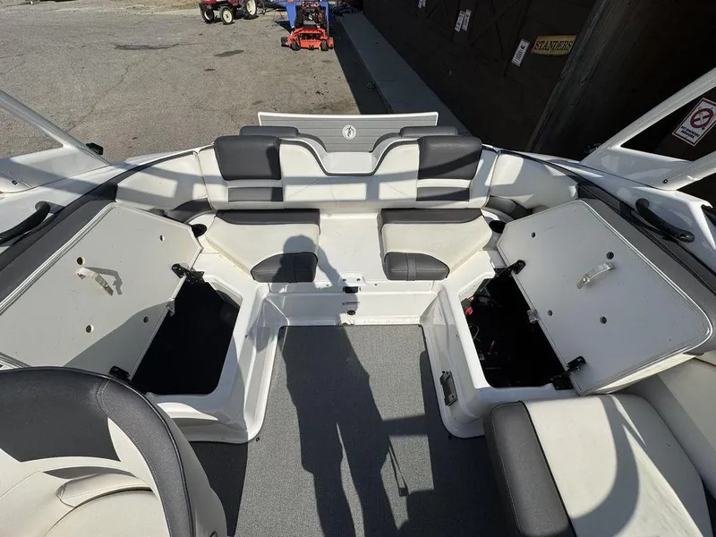 Slide: The Image of 2020 Yamaha AR210 boat interior with open storage compartments and seating. - 7