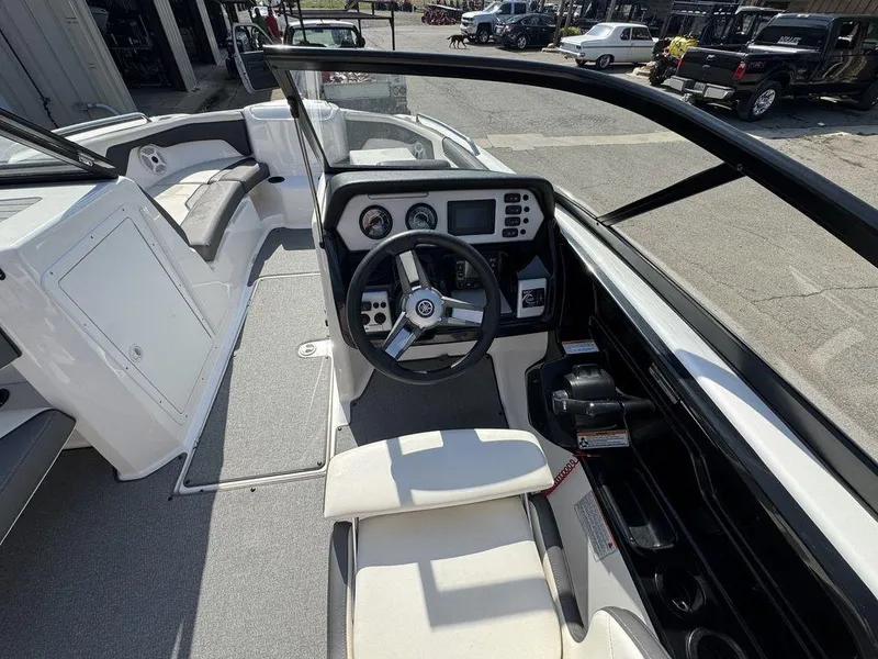 Slide: The Image of 2020 Yamaha AR210 boat cockpit with steering wheel and dashboard controls. - 8