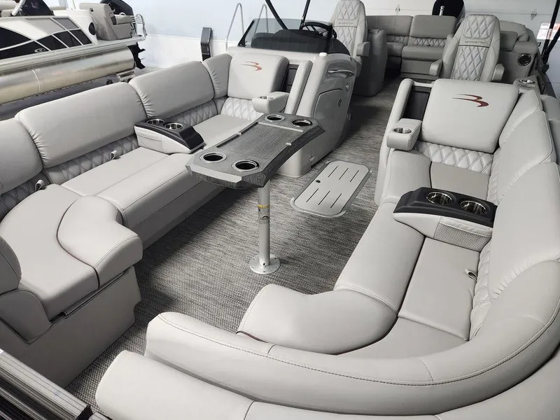 Slide: The Image of Luxurious interior of 2023 Bennington Marine 25RFBST pontoon boat with plush seating and table. - 11