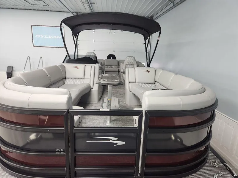 Slide: The Image of 2023 Bennington Marine 25RFBST pontoon boat with luxurious seating in a showroom. - 17