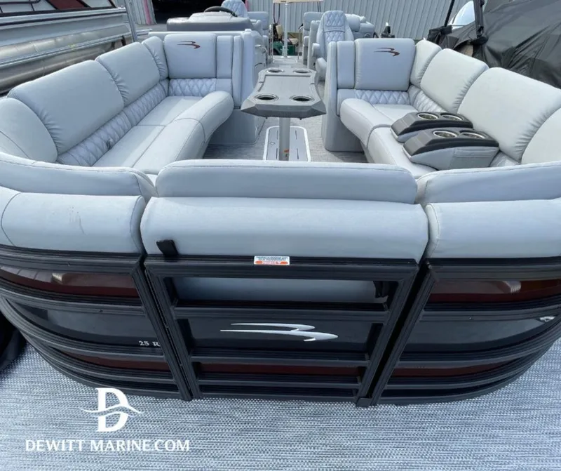 Slide: The Image of 2023 Bennington Marine 25RFBST pontoon boat with luxurious seating and table setup. - 2