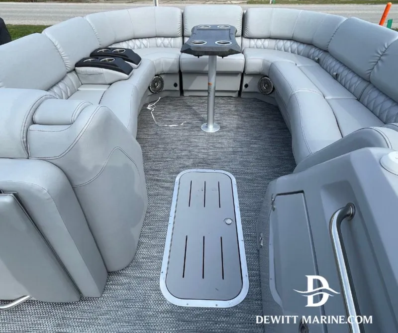 Slide: The Image of 2023 Bennington Marine 25RFBST pontoon boat interior with plush seating and table. - 4
