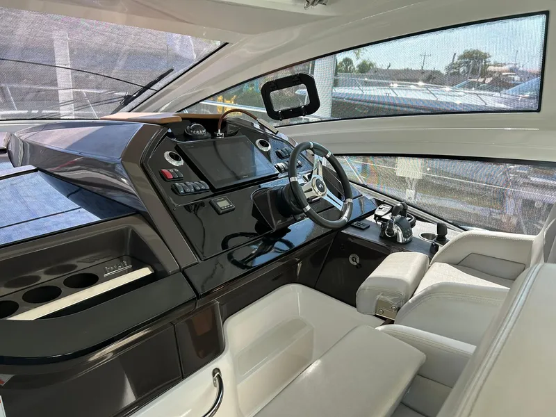Slide: The Image of Interior of 2019 Beneteau Gran Turismo 46 yacht, featuring modern helm and luxurious seating. - 11