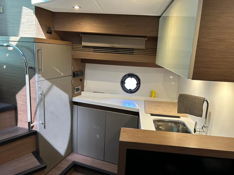 Slide: The Image of Modern kitchen interior of 2019 Beneteau Gran Turismo 46 yacht with sleek cabinetry and appliances. - 14