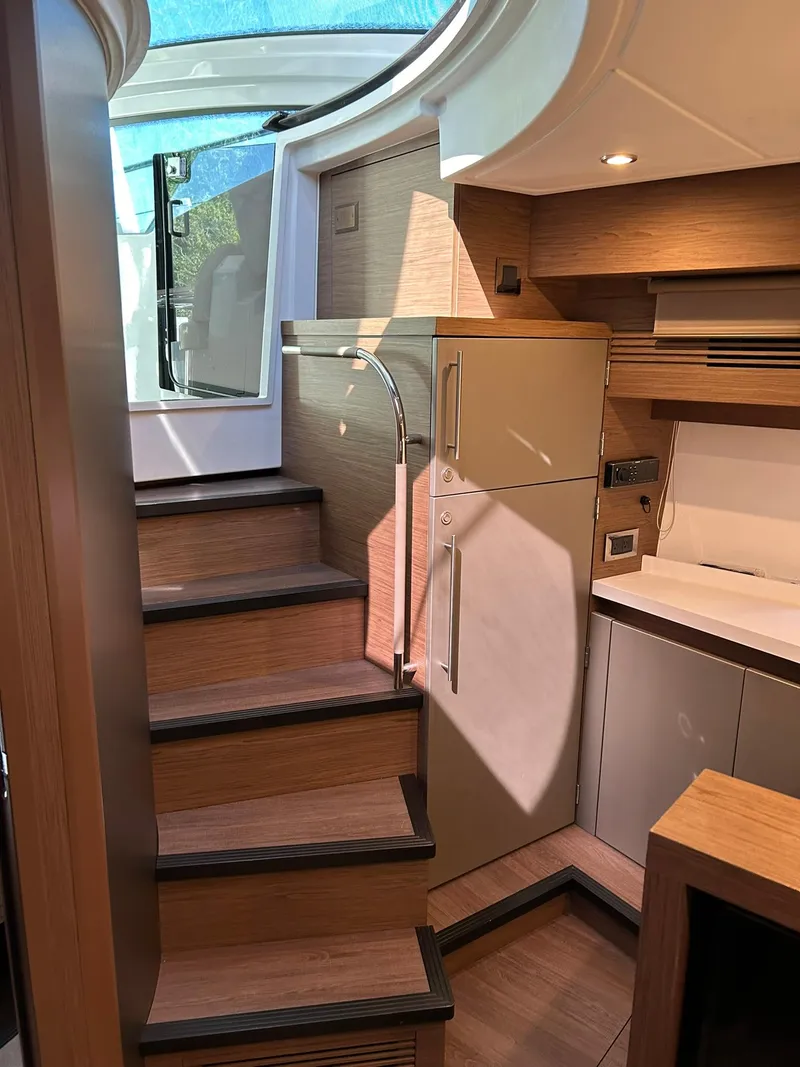 Slide: The Image of Interior view of 2019 Beneteau Gran Turismo 46 yacht with modern staircase and sleek design. - 17