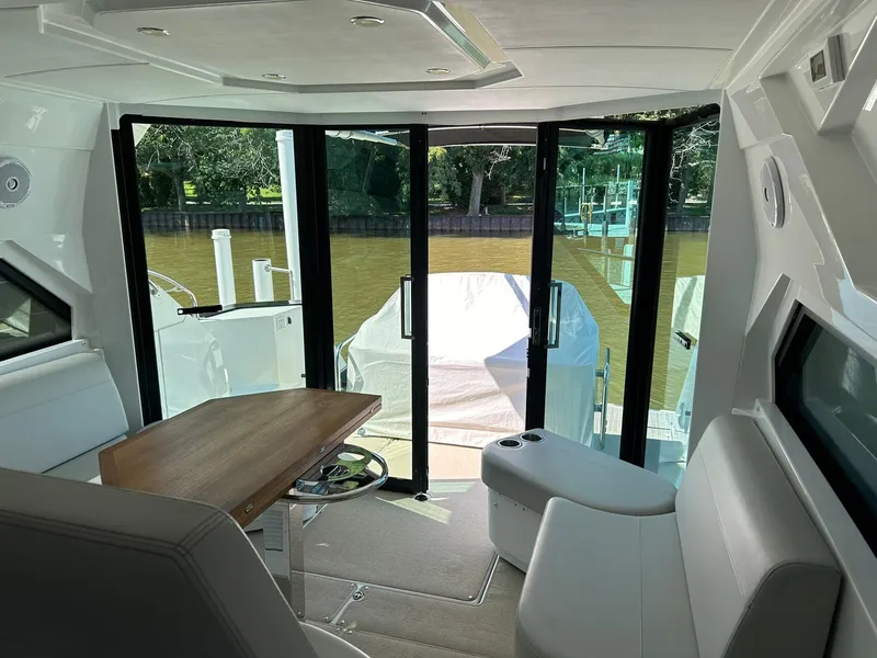 Slide: The Image of Interior of 2019 Beneteau Gran Turismo 46 yacht with seating and table, overlooking water. - 18