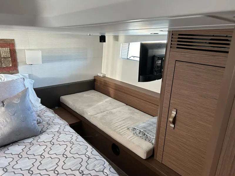 Slide: The Image of 2019 Beneteau Gran Turismo 46 cabin interior with bed, seating, and TV. - 20