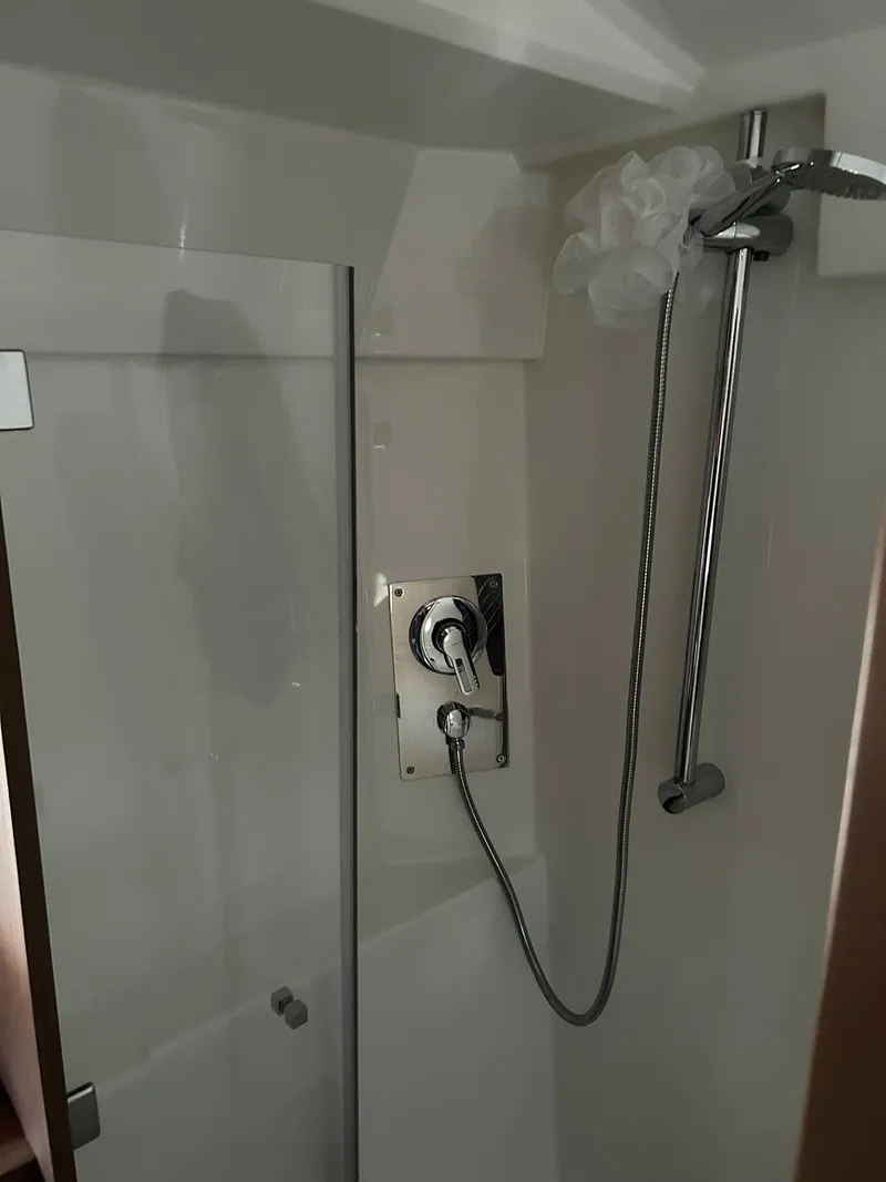Slide: The Image of Shower area in 2019 Beneteau Gran Turismo 46 yacht, featuring modern fixtures and glass door. - 28