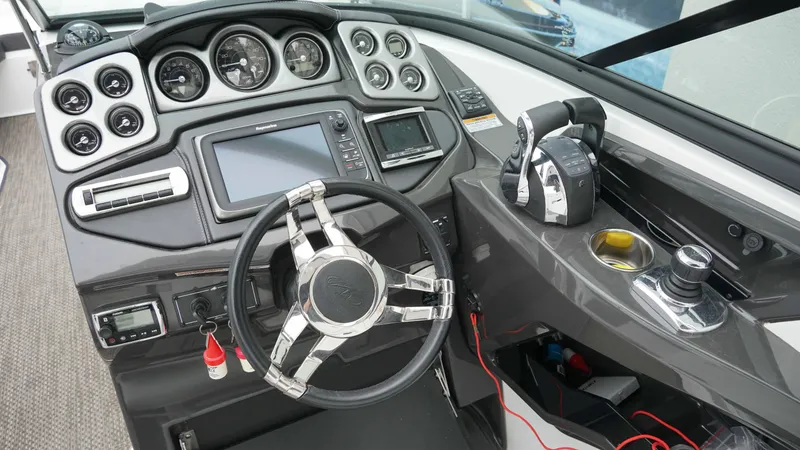 Slide: The Image of Cockpit of 2016 Monterey 328SS boat with steering wheel and control panel. - 10