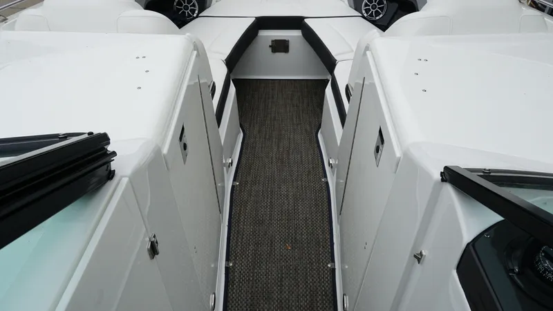 Slide: The Image of 2016 Monterey 328SS boat interior with white seating and carpeted walkway. - 12