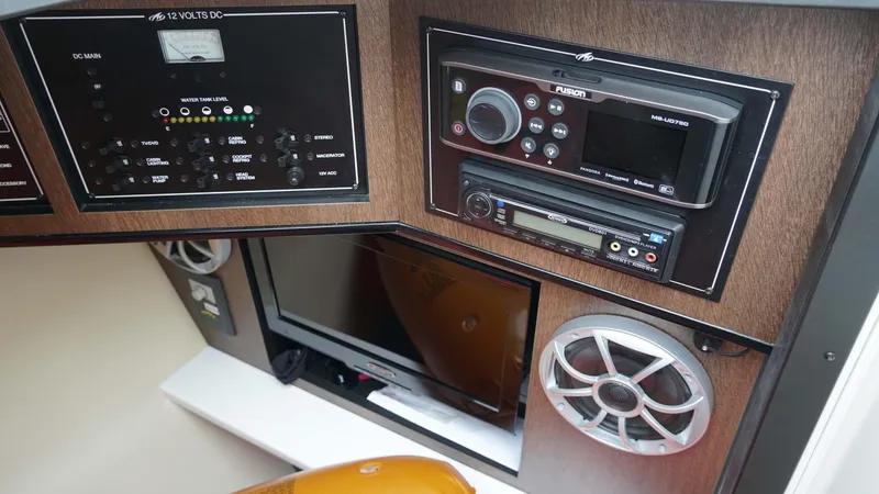 Slide: The Image of Control panel and audio system in a 2016 Monterey 328SS boat interior. - 13