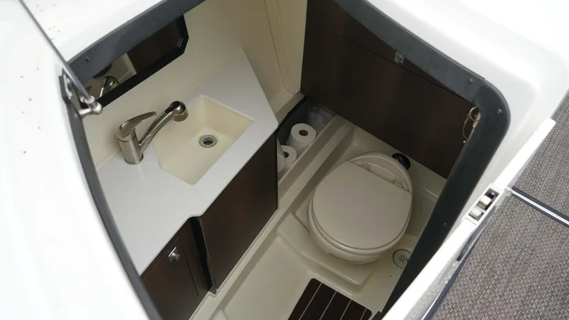 Slide: The Image of 2016 Monterey 328SS boat bathroom with sink, toilet, and storage cabinets. - 14