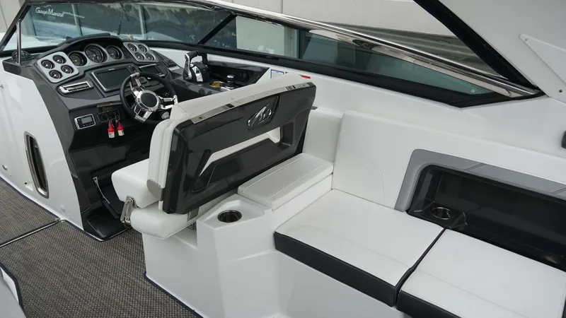 Slide: The Image of Interior of a 2016 Monterey 328SS boat, featuring a sleek dashboard and comfortable seating. - 9