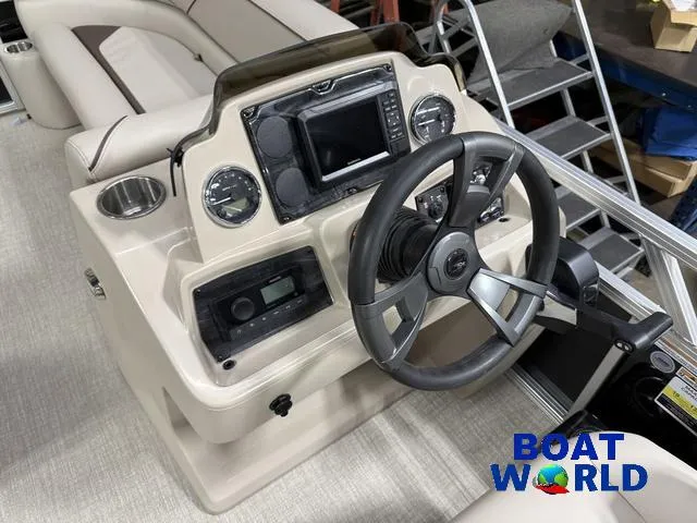 Slide: The Image of 2025 Tahoe Sport 2185 boat dashboard with steering wheel and controls, featuring Honda 4-Stroke EFI. - 13