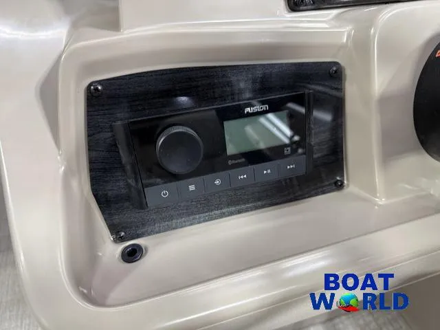 Slide: The Image of 2025 Tahoe Sport 2185 dashboard with Fusion audio system, featuring Bluetooth connectivity. Boat World logo visible. - 14