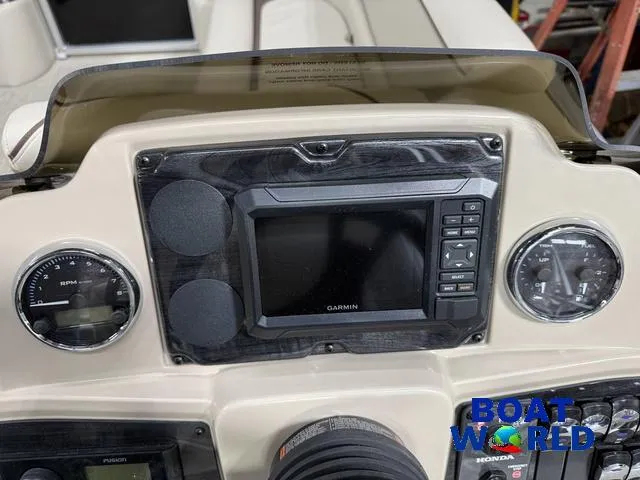 Slide: The Image of Dashboard of 2025 Tahoe Sport 2185 with Garmin display and Honda controls. - 15