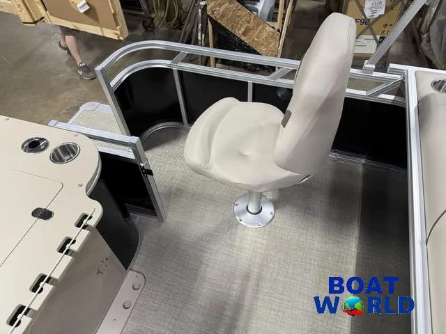 Slide: The Image of 2025 Tahoe Sport 2185 boat interior with swivel chair and railing, featuring Boat World logo. - 18