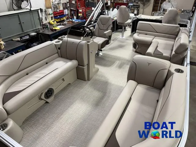 Slide: The Image of 2025 Tahoe Sport 2185 Rear Fish boat interior with beige seating and steering console. - 27