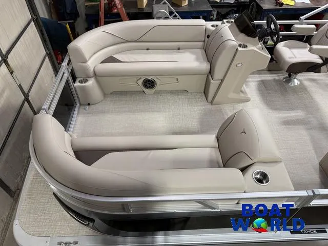 Slide: The Image of 2025 Tahoe Sport 2185 Rear Fish boat interior with beige seating and steering console. - 3