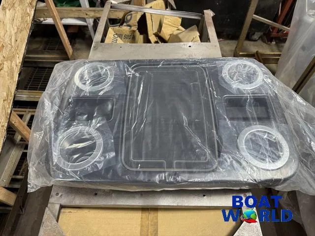 Slide: The Image of 2025 Tahoe Sport 2185 Rear Fish boat accessory, wrapped, on a workshop table. - 32