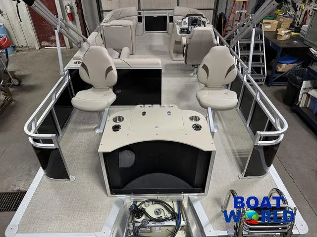 Slide: The Image of 2025 Tahoe Sport 2185 Rear Fish boat interior with seating and control panel, in a workshop setting. - 6