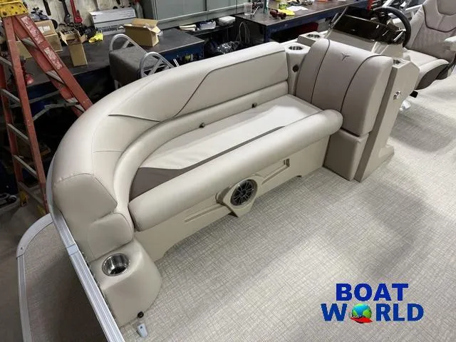Slide: The Image of 2025 Tahoe Sport 2185 boat interior with beige seating and cup holders, showcased at Boat World. - 8