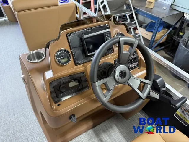 Slide: The Image of 2025 Tahoe Sport 2385 Tritoon dashboard with steering wheel and controls. - 13