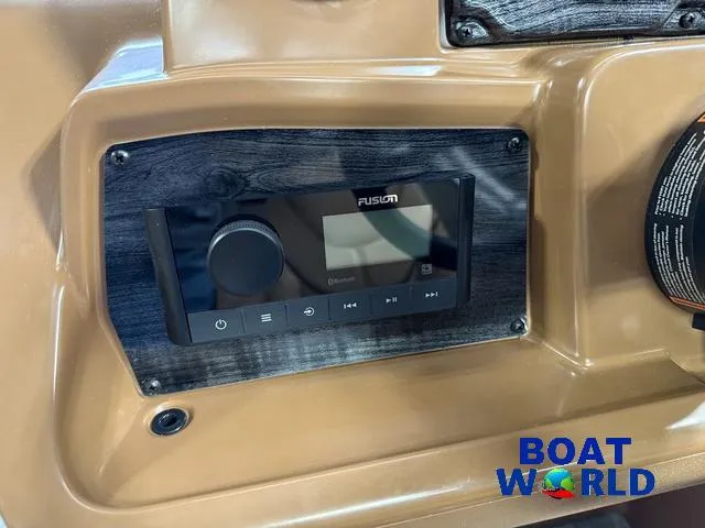 Slide: The Image of Control panel of 2025 Tahoe Sport 2385 Tritoon with Fusion audio system. - 14