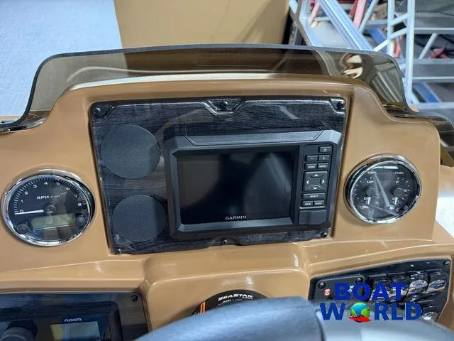 Slide: The Image of Dashboard of 2025 Tahoe Sport 2385 Tritoon with Garmin display and gauges. - 15