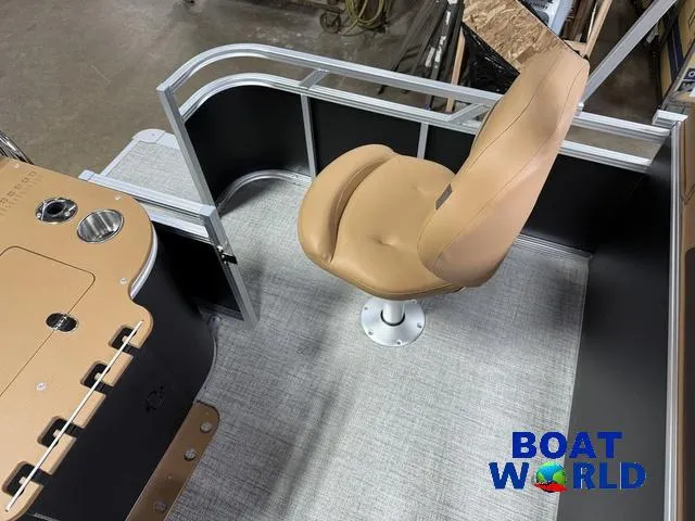 Slide: The Image of 2025 Tahoe Sport 2385 Tritoon interior with tan seat and control panel, Boat World logo. - 18