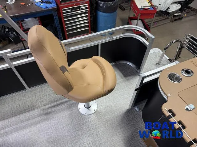 Slide: The Image of 2025 Tahoe Sport 2385 Tritoon boat interior with tan swivel seat and control panel. - 19