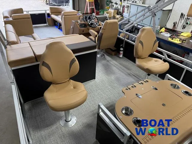 Slide: The Image of 2025 Tahoe Sport 2385 Rear Fish Tritoon interior with tan seating and fishing setup. - 21