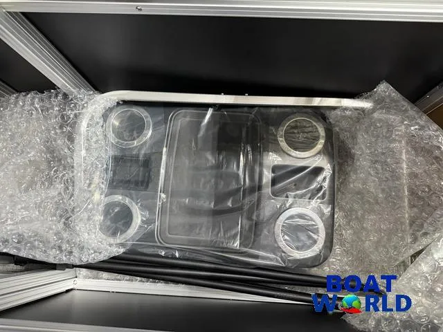 Slide: The Image of 2025 Tahoe Sport 2385 Rear Fish Tritoon console, wrapped in bubble wrap, Boat World logo visible. - 24