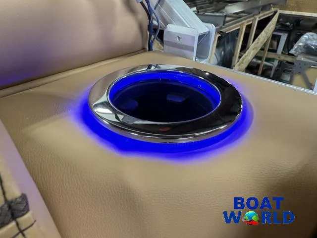 Slide: The Image of Illuminated cup holder on 2025 Tahoe Sport 2385 Rear Fish Tritoon boat, featuring blue LED lighting. - 27