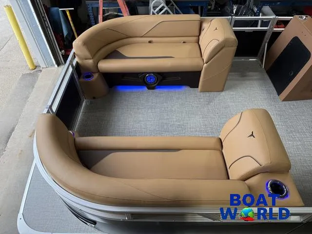 Slide: The Image of 2025 Tahoe Sport 2385 Tritoon interior with tan seating and blue LED lighting. - 3