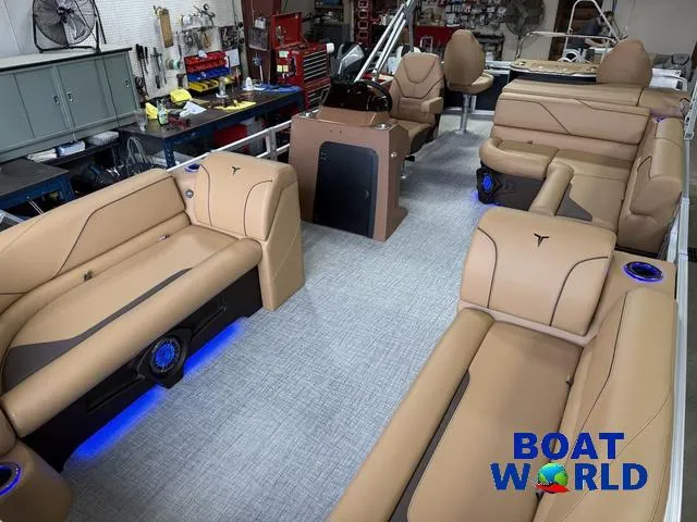Slide: The Image of Luxurious interior of 2025 Tahoe Sport 2385 Tritoon with tan seating and blue LED lighting. - 30