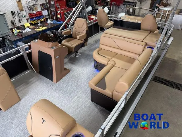 Slide: The Image of 2025 Tahoe Sport 2385 Tritoon interior with tan seating and modern design. - 4