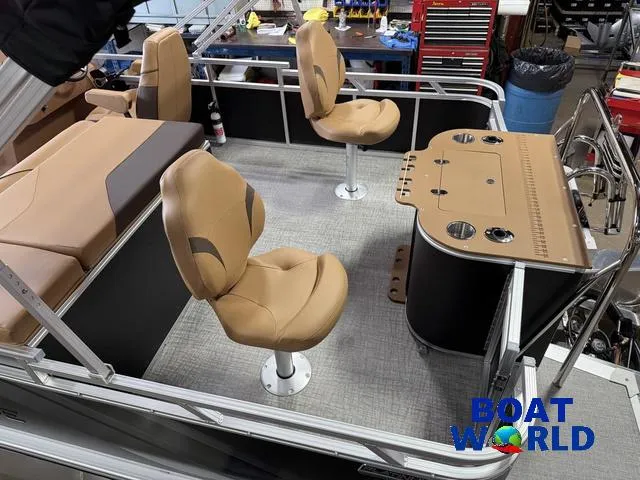 Slide: The Image of 2025 Tahoe Sport 2385 Tritoon interior with tan seating and fishing station. - 5