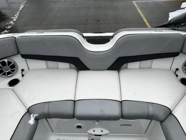 Slide: The Image of 2012 Yamaha Boats 212X interior seating with gray and white upholstery. - 12