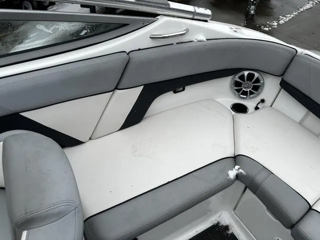 Slide: The Image of Interior seating of a 2012 Yamaha Boats 212X, featuring gray and white upholstery. - 13