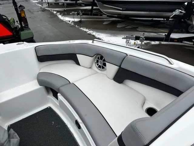 Slide: The Image of 2012 Yamaha Boats 212X interior seating with gray and white upholstery, featuring a speaker. - 15