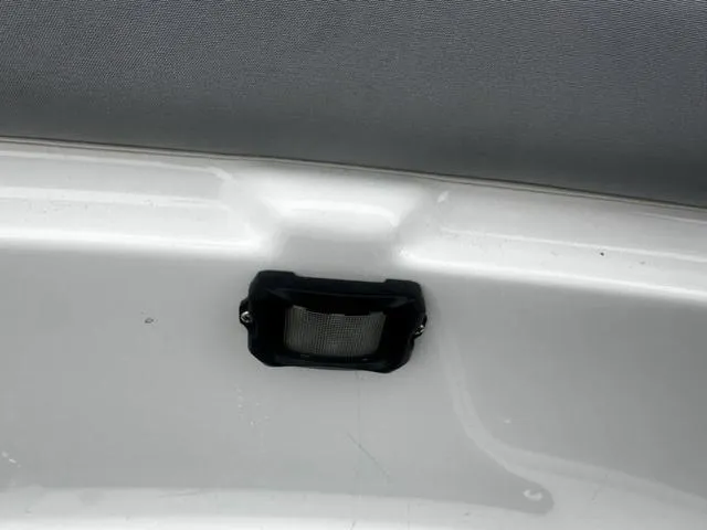 Slide: The Image of 2012 Yamaha Boats 212X interior detail with a black vent on a white surface. - 17