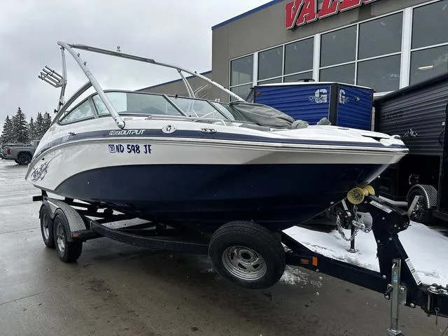 Slide: The Image of 2012 Yamaha Boats 212X on trailer, parked outdoors near a building, with overcast sky. - 3