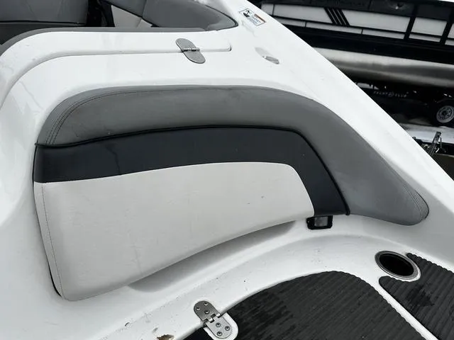 Slide: The Image of 2012 Yamaha Boats 212X interior seating with white and gray upholstery. - 8