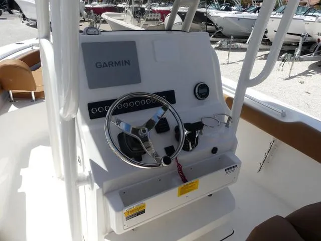 Slide: The Image of 2025 Key West 239 FS boat console with Garmin navigation system and steering wheel. - 10
