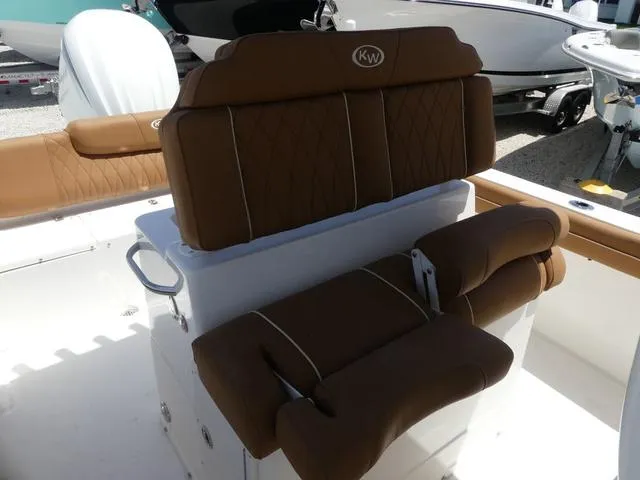 Slide: The Image of 2025 Key West 239 FS boat with brown cushioned seating and white deck. - 12
