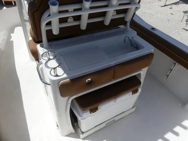 Slide: The Image of 2025 Key West 239 FS boat interior with sink, rod holders, and storage. - 14