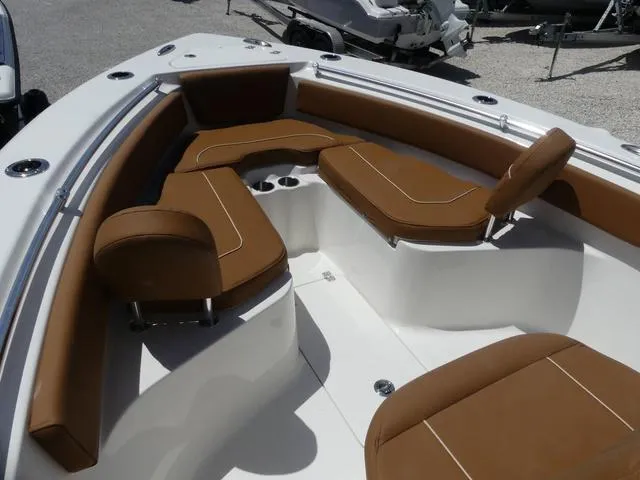 Slide: The Image of 2025 Key West 239 FS boat interior with brown cushioned seating and cup holders. - 15