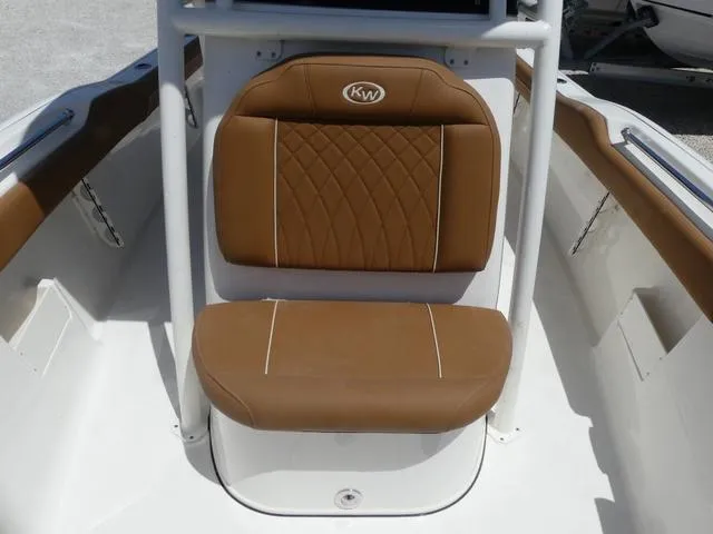 Slide: The Image of 2025 Key West 239 FS boat seat with brown cushioned upholstery and white accents. - 17