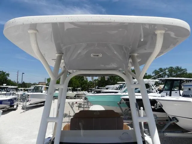 Slide: The Image of 2025 Key West 239 FS boat with T-top, docked under clear blue sky. - 18